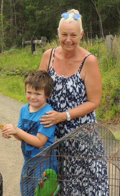 Karen Bull (with son Levi) spent Sunday relocating her horses and birds before the bush fire hit Wortley Drive, near Crescent Head, on Monday, threatening her home.