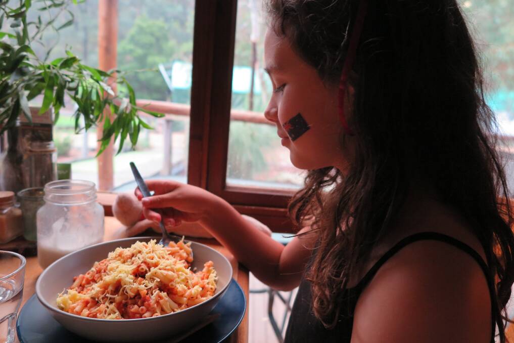 Linda's daughter Angeline enjoys vegan pasta at Secret Creek Cafe.