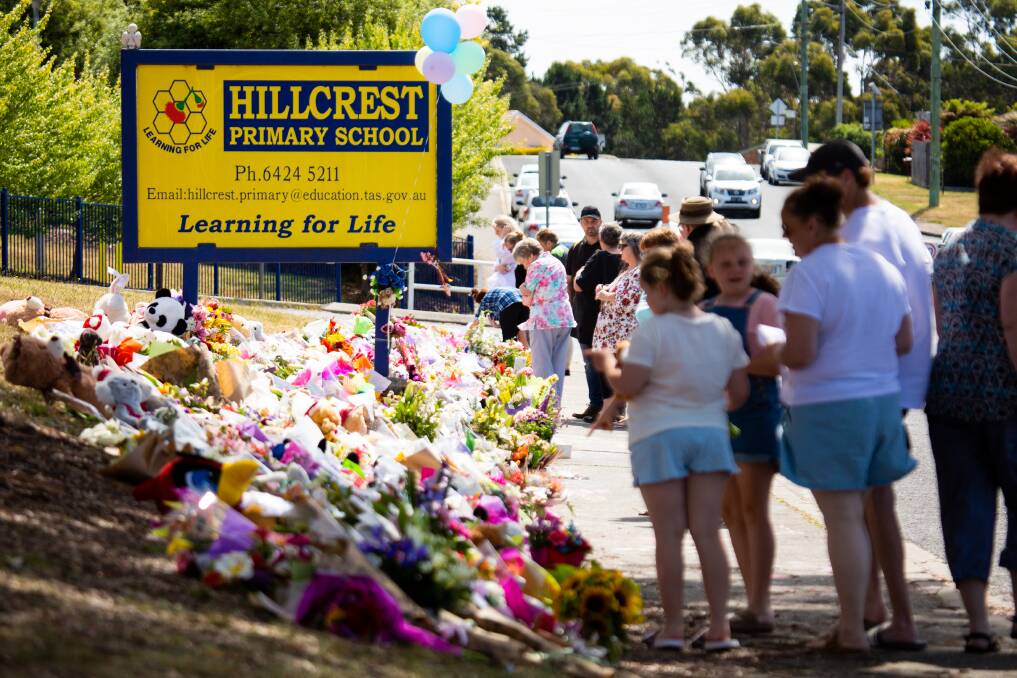 Members of the public laying tributes outside the Hillcrest Primary School in the days after the tragedy in December 2021.