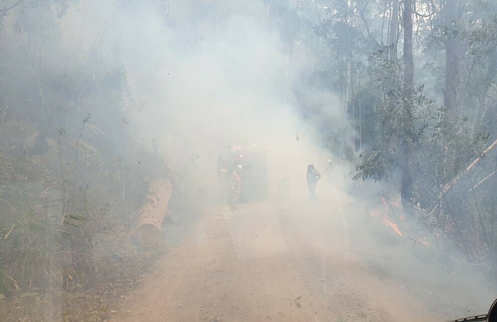 Photo taken by the Nambucca Headquarters Rural Fire Brigade at the Kian Rd fire: "Our crew of 5 encountered plenty of smoke and dust but got a nice wash from overhead as the chopper dropped a couple of buckets on a spot over. Water conservation was a high priority as well as watching out for Death Adders."