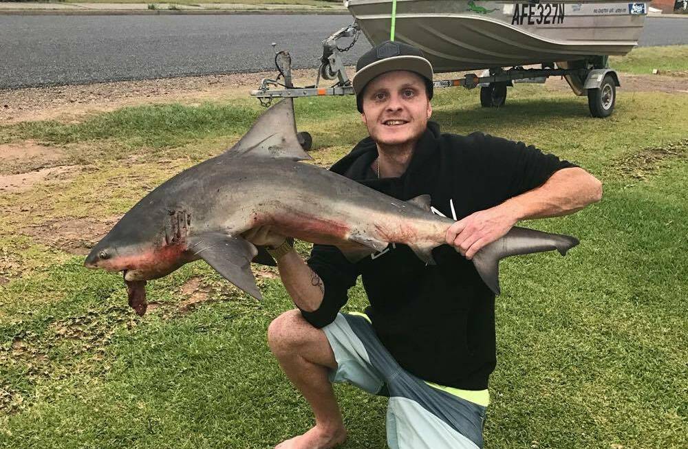 Solid shark: Jamie Leeder with a 1.5m bull shark caught earlier this year, one of the many he and Jarrad Smith have caught. Photo: Supplied. 