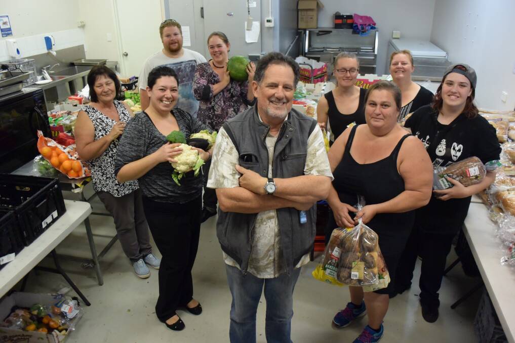 Filling stomachs: Dave Davis (front) with the team of committed volunteers that help feed more than 900 kids around the Macleay with three tons of donated food each week. 