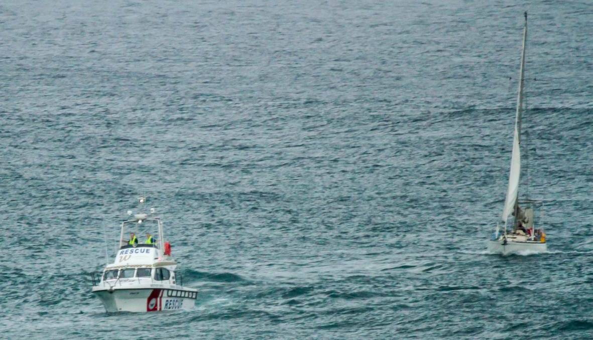Early morning rescue: Marine Rescue tow the yacht to Port Macquarie early on Thursday morning. Photo: Gaz White