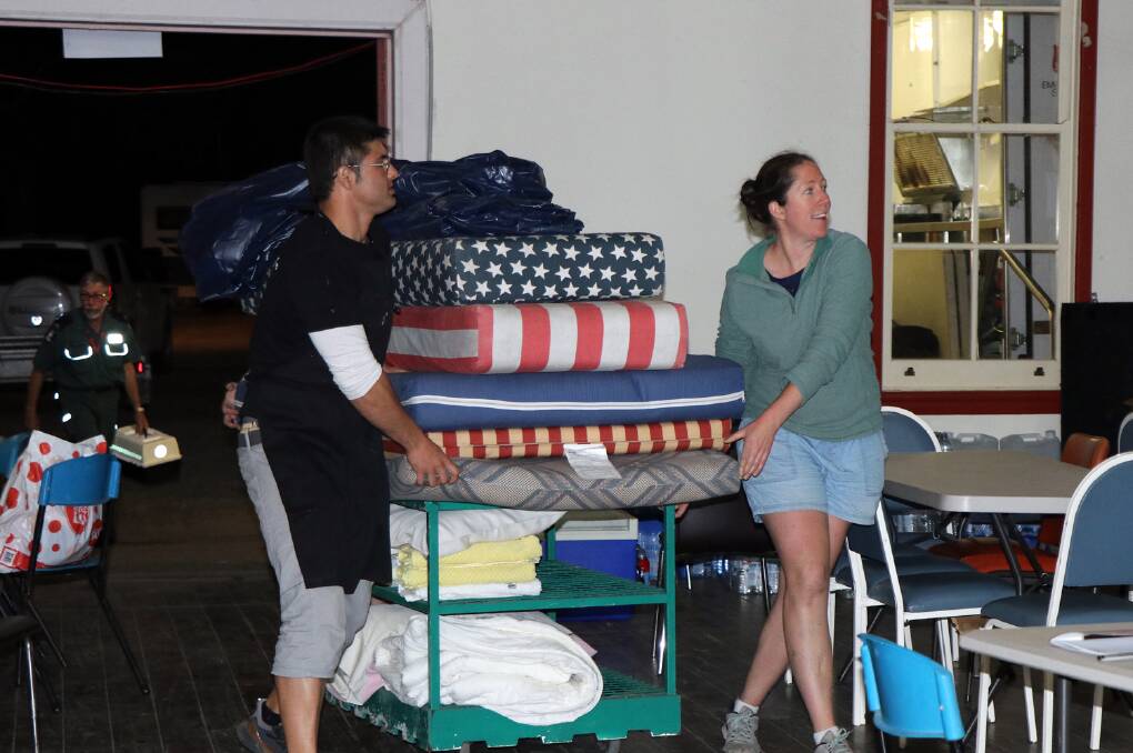 Support: Volunteers deliver bedding for residents taking shelter at the evacuation centre at Kempsey Showground.