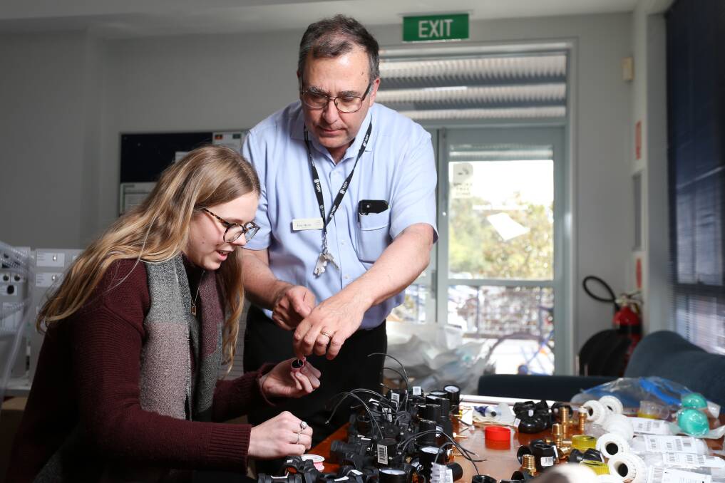BIT BY BIT: Eric Moyle, an Albury doctor and conjoint lecturer for the UNSW Rural Clinical School Albury campus, walks sixth-year-student Carla Hensel through parts required to create a makeshift ventilator. Picture: JAMES WILTSHIRE