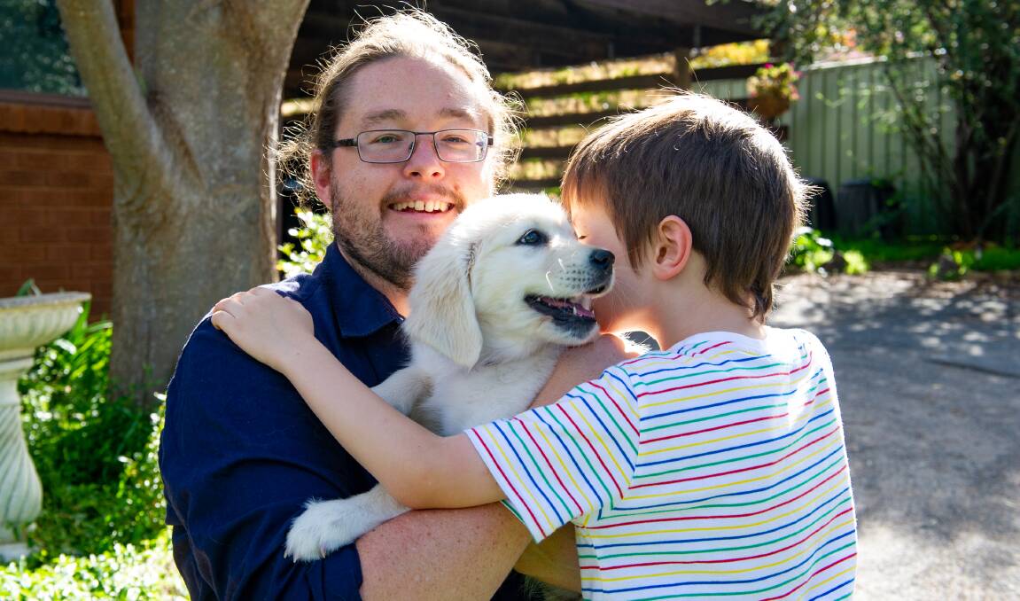 Brad Tucker and his six-year-old son with his new puppy Luna. Picture: Elesa Kurtz
