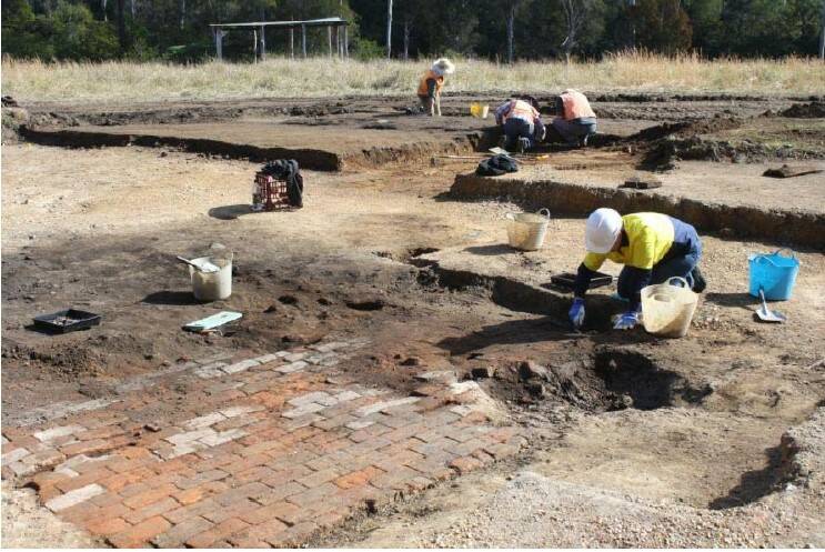An archaeologist excavating the hut floor at Ravenswood (Photo Niche Environment and Heritage)