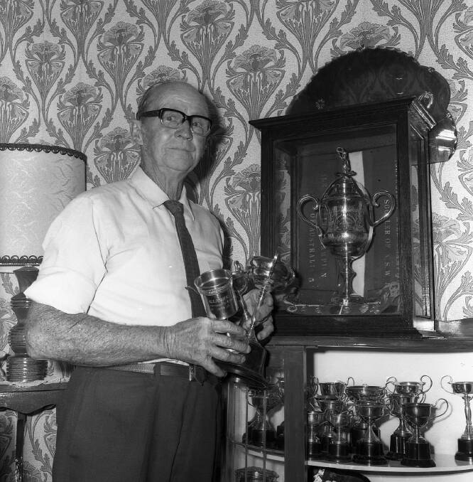 Tom Saul with some of his rowing trophies at his home (Macleay Argus Collection, MRHS)