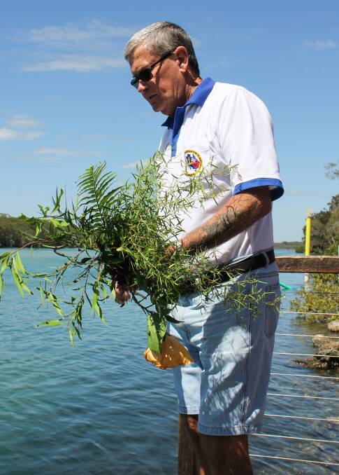 A wreath is cast into the Nambucca River in memory of those who perished in the HMAS Voyager disaster 55 years ago 