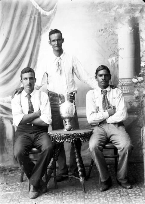 Three of the True Australians cricketers with the Hart Challenge Cup, possibly Jim Linwood in centre. Photo: Macleay River Historical Society, Angus McNeil Collection