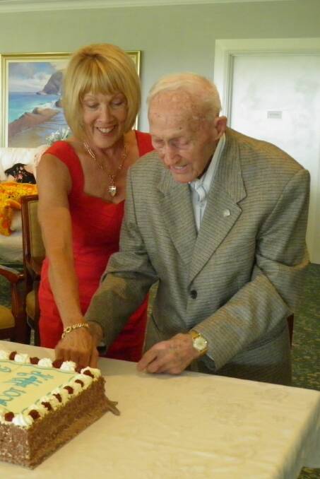 100th birthday: Centenarian Jack Lasserre cuts his birthday cake with daughter Yvonne Harvey.
