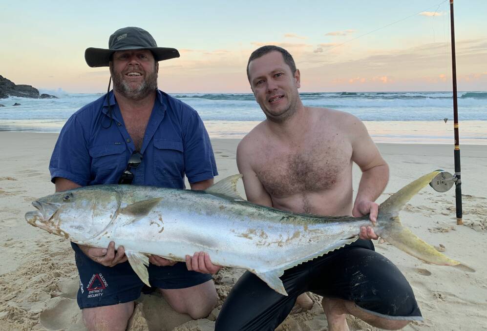 After a long fight which lasted over an hour, Matt Cowden (left) lands a 24kg kingfish at South West Rocks. Pictured with Nathan Moore. Photo supplied.