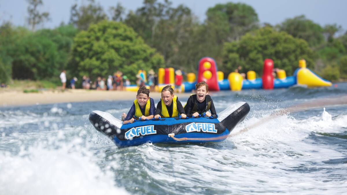 Kids from the Junior Summer Camp water tubing at Stuarts Point waterfront. Photo supplied.