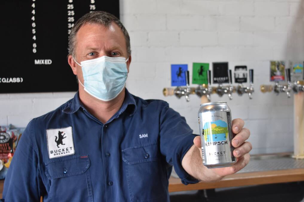 Sam Preston with the latest line of beer from Bucket Brewery. Photo: Lachlan Harper 