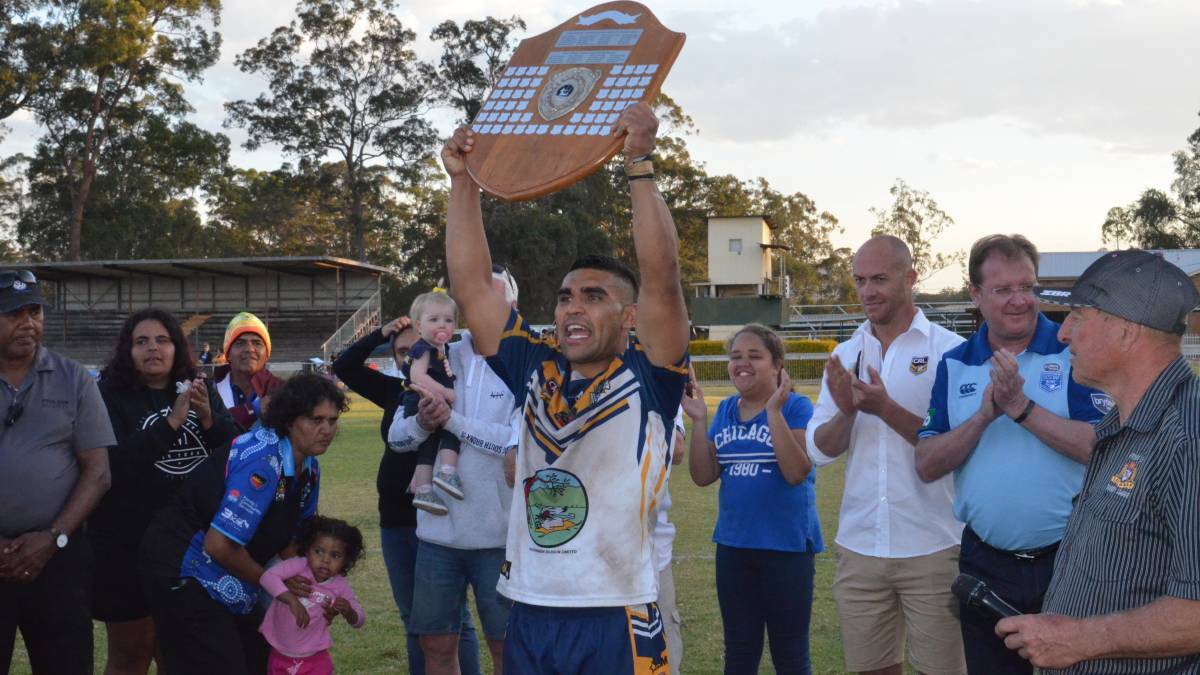 Macleay Valley Mustangs, Richie Roberts, holds the trophy aloft. Photo: File