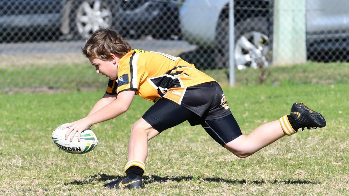 One of the Smithtown Tigers 10s players goes over for a try earlier this year. Photo: Penny Tamblyn 