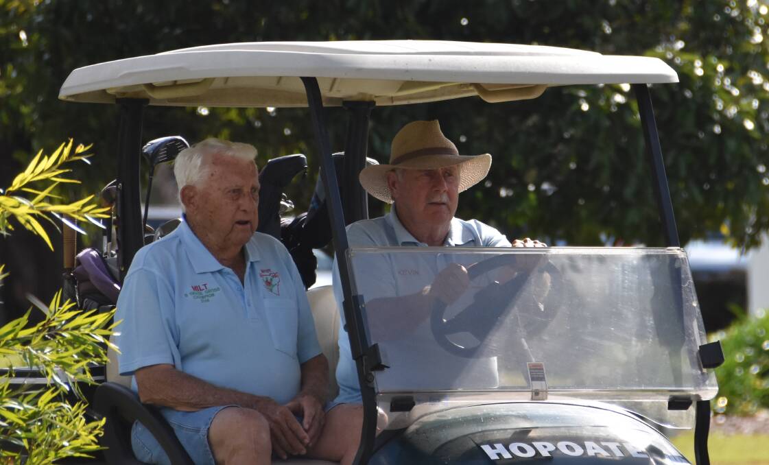 Kevin Hopping chauffeurs Milton Riggs around the Kempsey Golf course. Photo: Lachlan Harper