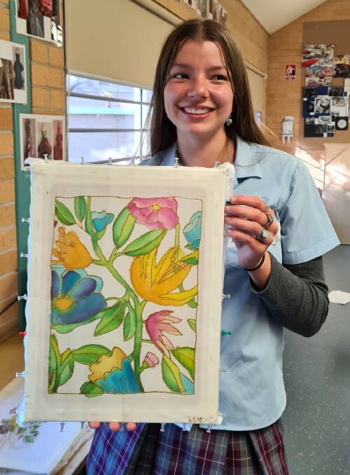 Melville student Indrani and her completed silk painting. Photo: Supplied 