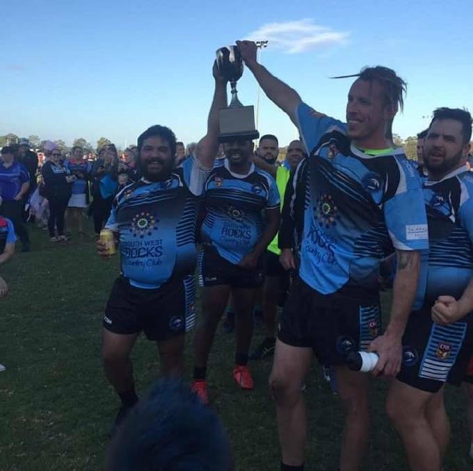 Marlins co-coaches Sam Drew and Sam Howe proudly lift the Hastings League trophy. Photo: Supplied