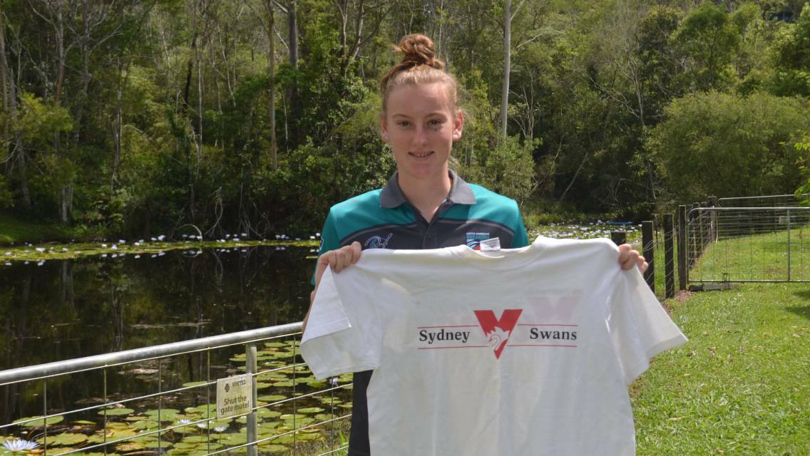 April Devine holds her great-grandfather's Sydney Swans shirt. Photo: File 