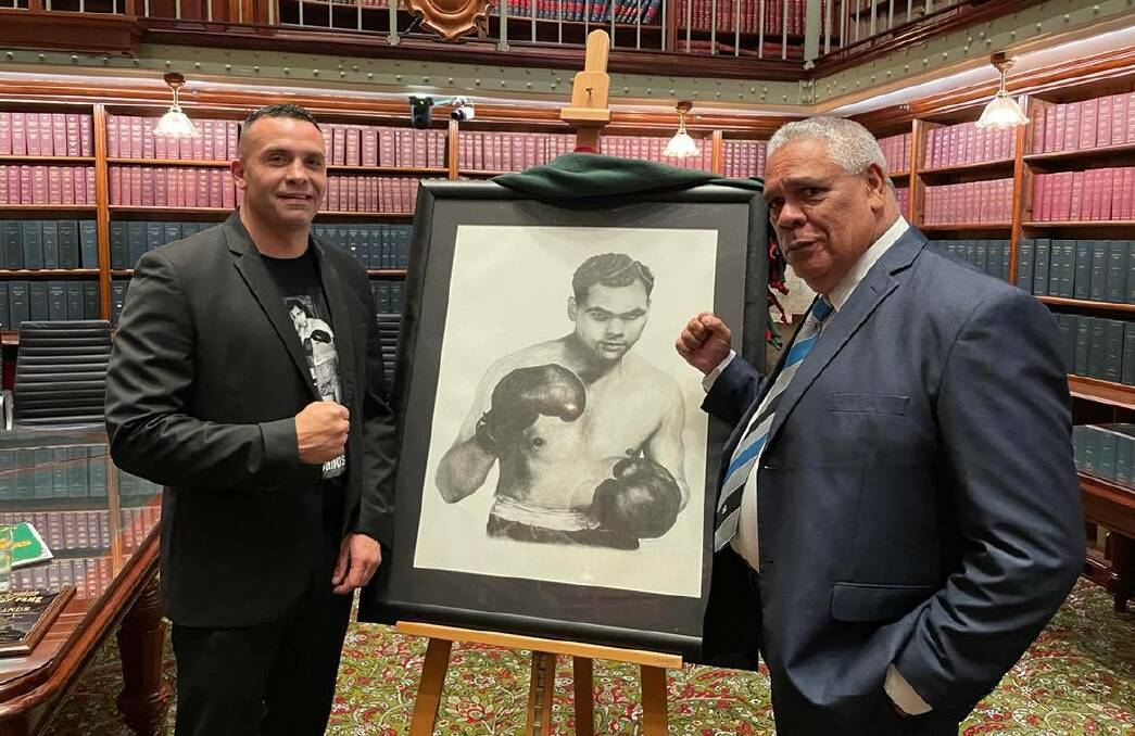 SIMPLY BRILLIANT: Chad Ritchie Sands and Phillip Dotti in front of Eric Carney's portrait of Dave Sands. Photo: LACHLAN HARPER 