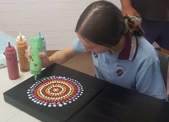 Melville High student Teneisha putting the finishing touches on her traditional artwork. Photo: Supplied 