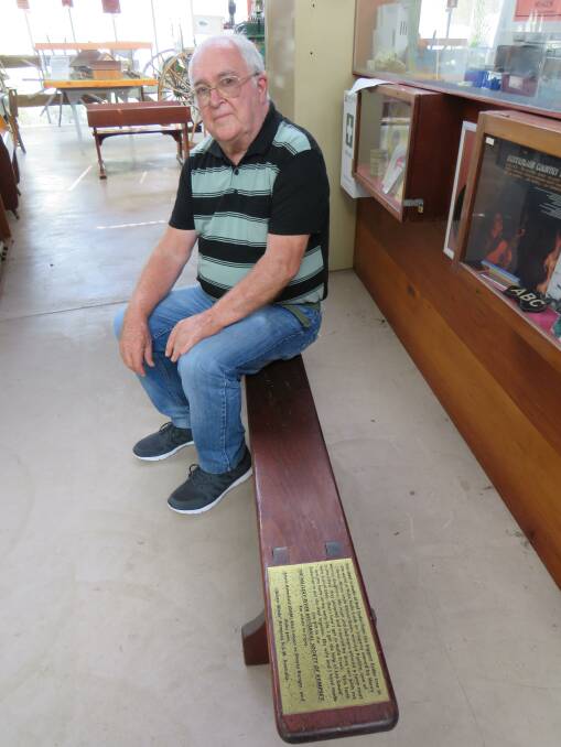 Society member Phil Lee sits on the bench made from the world's biggest cedar tree. It's on display at the museum. 
