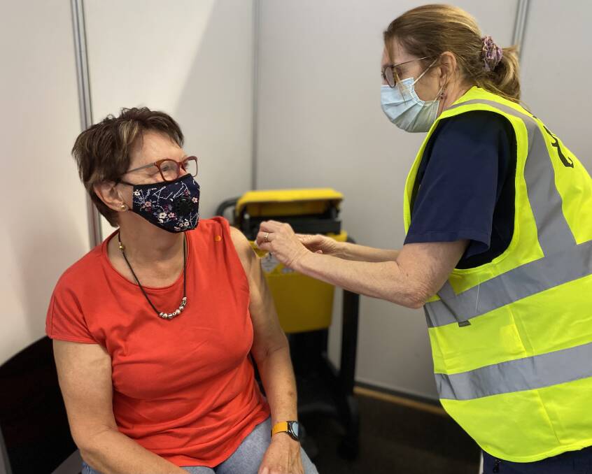 Judy Beilby receives her vaccination from nurse Annie Van de Jagt. Photo: NSW Health.