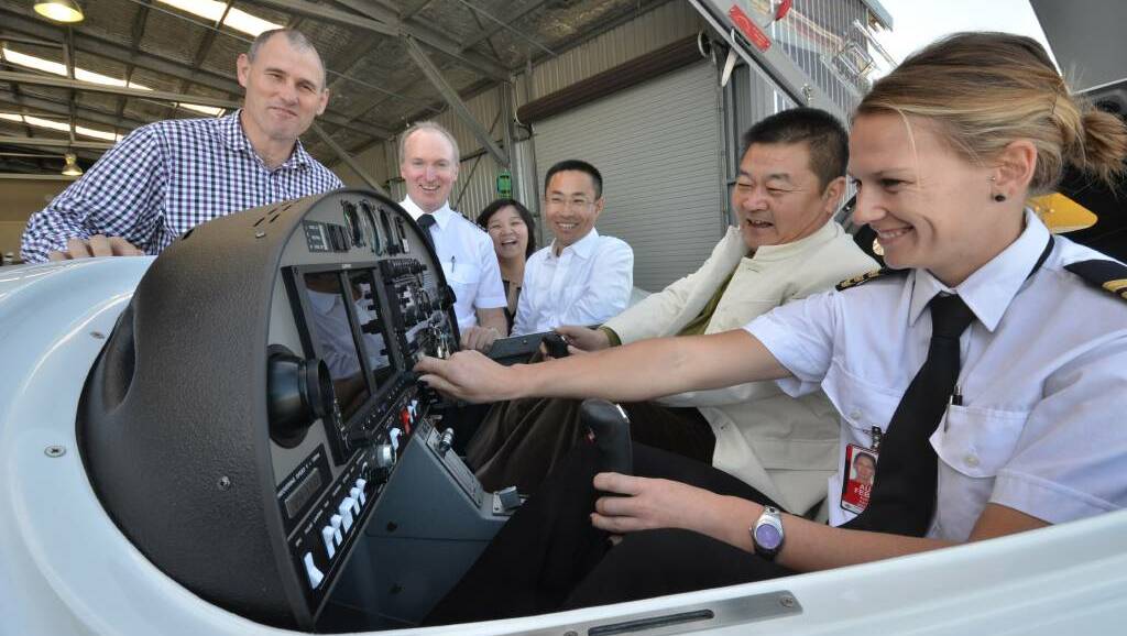 Back to 2013: Mayor Peter Besseling, chief pilot Kevin McMurtrie, Arena International Aviation’s Li Li, Tian Wei from Hainan Airlines Group, Arena International Aviation chairman Li Chunming and flight instructor Ashlee Hayes inspect one of the new Diamond aircraft.