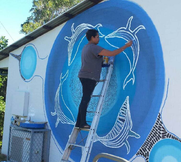 WHALE FEEDING: Tamikar Buchanan putting the finishing touches on the new VIC mural