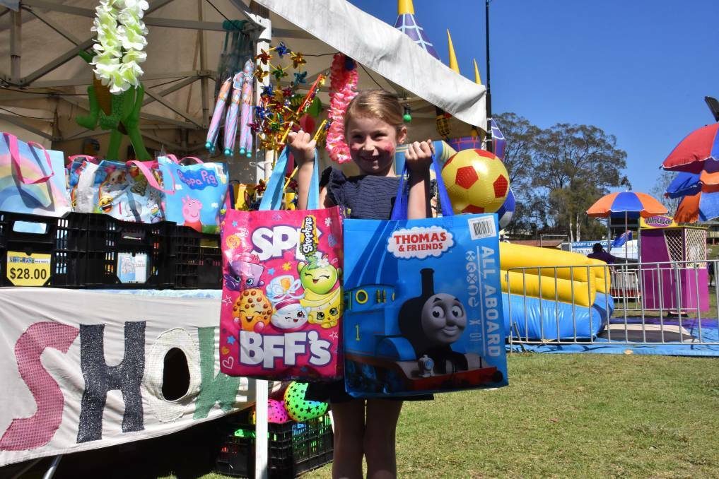 SHOWBAGS: Kiera Ansell with an array of fun goodies at the Camden Haven Show in 2019.