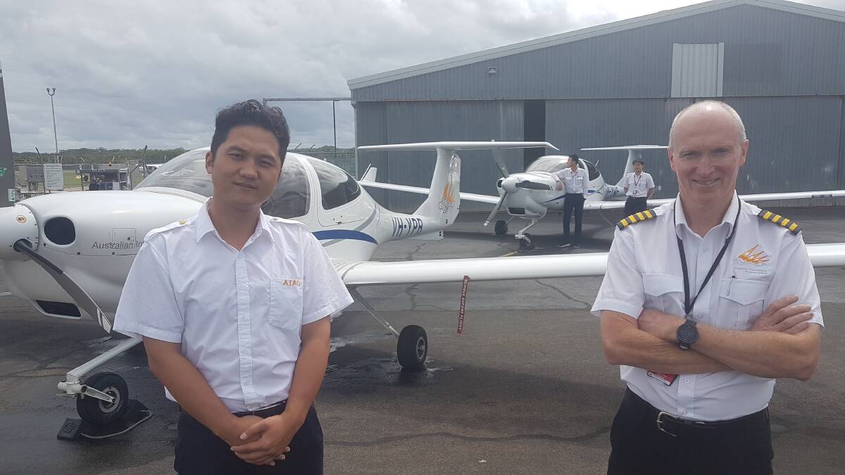 CADETS TARGETED: Cadet airline pilot Frank Qun with Australian International Aviation School head of operations and chief pilot Kevin McMurtrie.