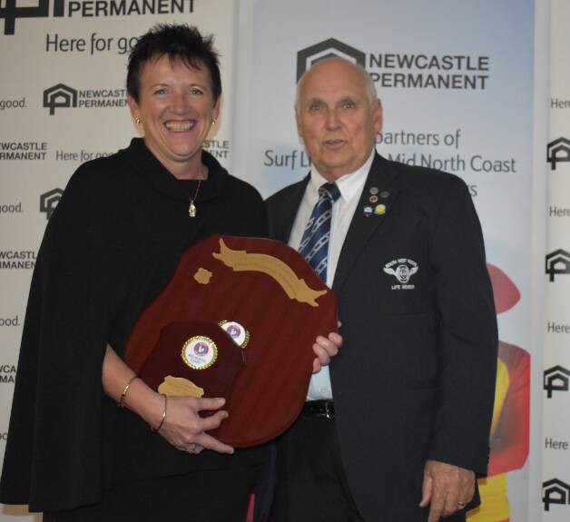 Hardworking volunteers: Sandra Slattery from Tacking Point SLSC being presented with the Volunteer of the Year Award from SLSMNC Life Member, Bruce Caldwell. Photo: Supplied/SLSMNC.