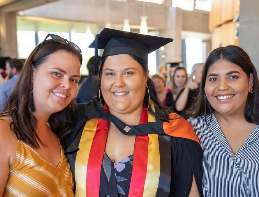 April Collins (centre) at her graduation on February 5. Photo: Supplied