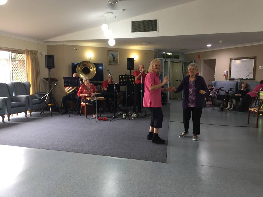 Recreational activities officer Donna Gill and resident Carole enjoying the music