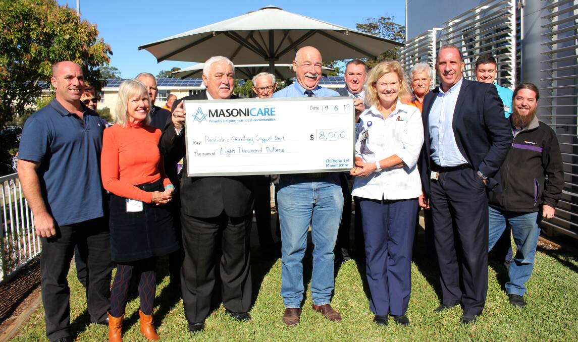 Freemasons Alan Williams and Robert Drysdale (centre) handed over a $8000 cheque to the Mid North Coast Cancer Institutes Sara Shaughnessy and Jenny Baroutis. With them are Masons representing Masonicare and the Lodges of the Hastings Macleay Freemasons Association. Photo: Supplied