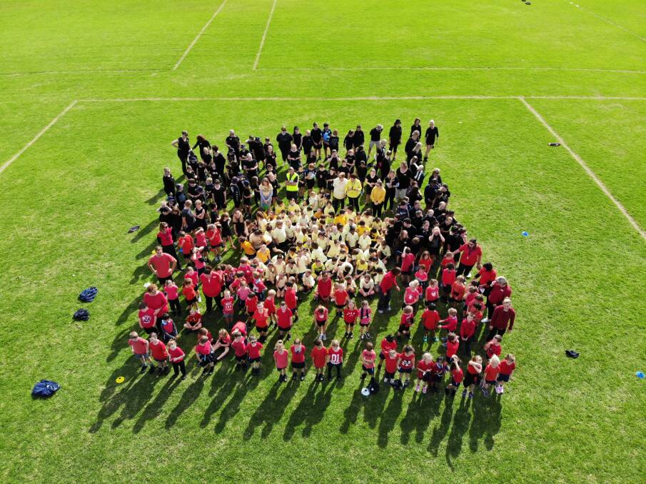 St Joseph's Primary School students created a human Aboriginal Falg at the school today. Photo: St Joseph's Primary School