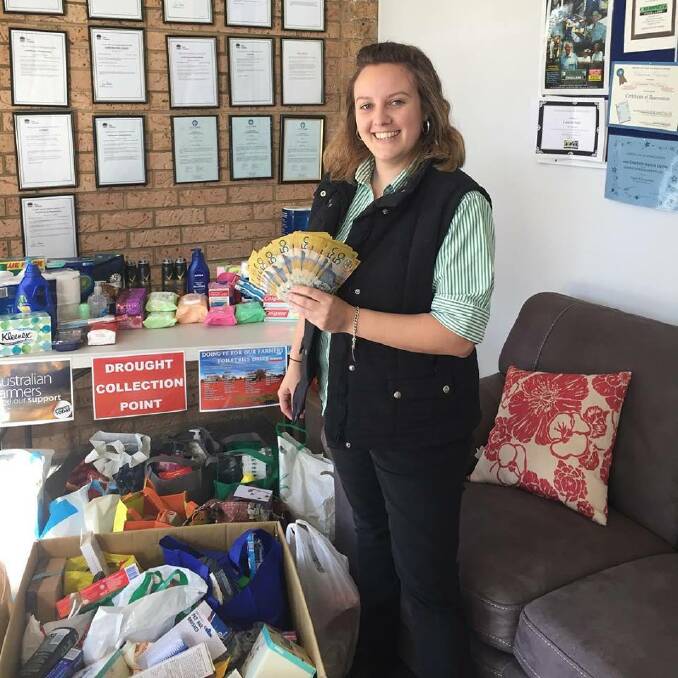 Donations: Samantha Hughes from Kempsey Stock & Land with the anonymous $2500 donation. Photo: Supplied