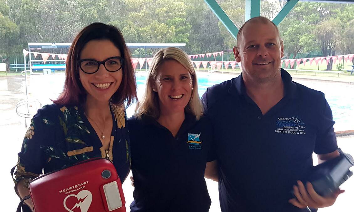 Councils Property and Facilities Officer, Fiona Paix (centre), delivers a defibrillator to Crescent Aquatic Centre managers, Renee and Mason Marchment. Photo: Supplied