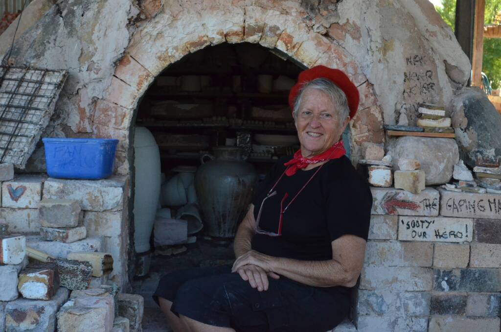 Jann Kesby with the packed kiln ready for firing. Photo: Ruby Pascoe