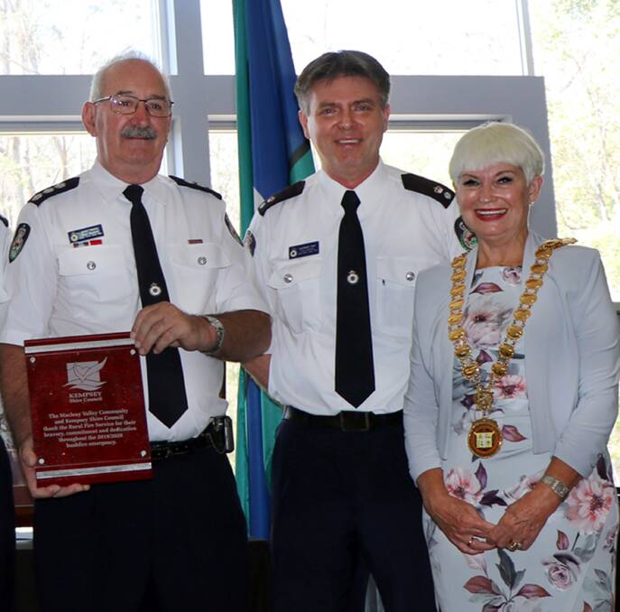 RFS Superintendent Lachlann Ison and Group Captain Paul Bourne accepting a plaque of thanks from Kempsey Shire Mayor Liz Campbell on Australia Day. Photo: Supplied