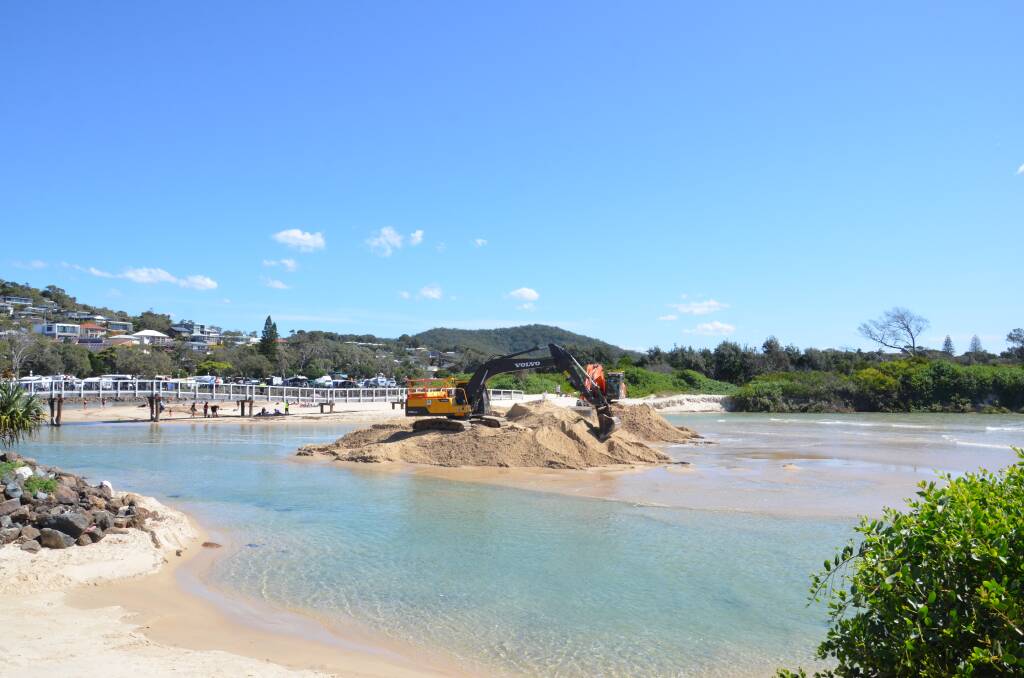 Council staff worked throughout yesterday to cut a pilot channel. Photo: Ruby Pascoe