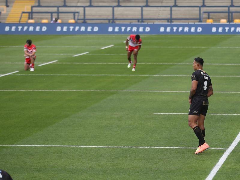 Israel Folau remained standing as players knelt in support of the Black Lives Matter campaign.