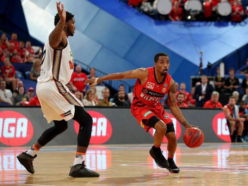 Bryce Cotton (r) scored 14 points in the final term and nine in overtime as Perth beat the Taipans.