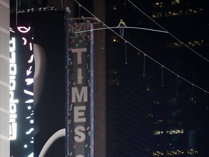 Aerialist Nik Wallenda walks on a high wire above Times Square in New York.