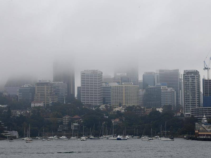 Fog blanketing Sydney caused flight delays and a visibility warning for road users on Saturday.
