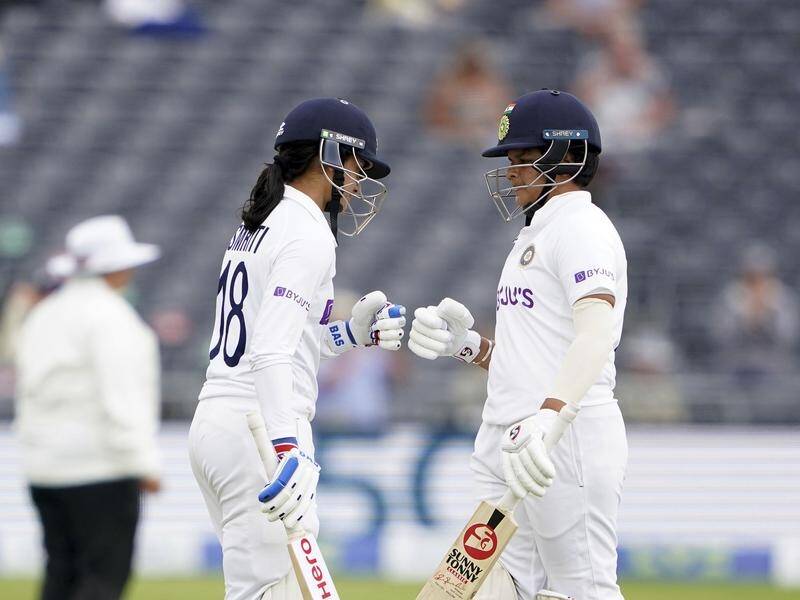 India's Smriti Mandhana (l) and the brilliant Shafali Verma bump fists during their century stand.