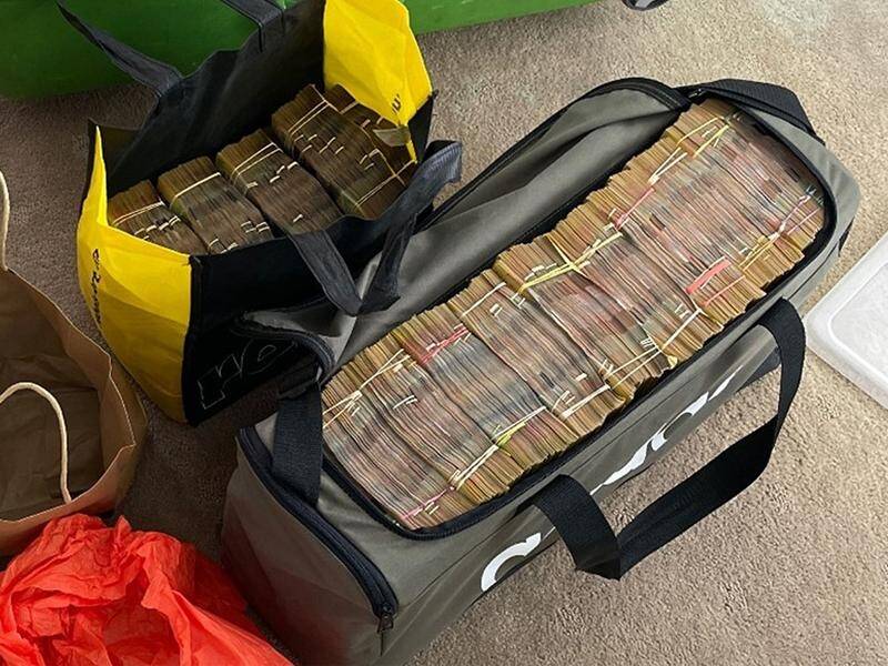Two Russians face money laundering charges after $2 million in cash and cryptocurrency was seized. (HANDOUT/AUSTRALIAN FEDERAL POLICE)