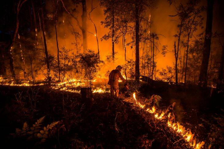 NSW RFS crews make the most of cooler temperatures tonight and tidy up within containment lines at an old hazard reduction in Bowen Mountain. 13th September 2017, Photo: Wolter Peeters, The Sydney Morning Herald.