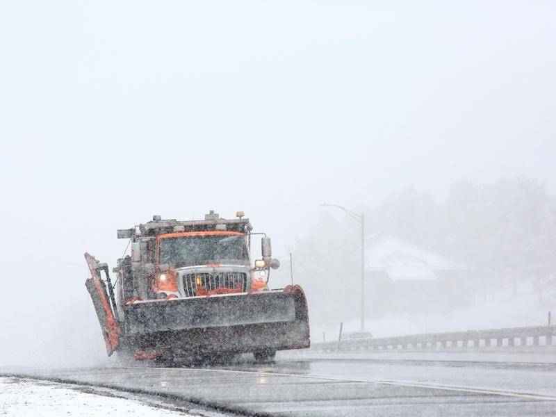 A snowplough clears the way in Colorado, where 60cm of snow is forecast over 72 hours.